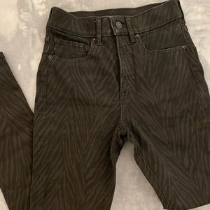 Express black jeans with subtle animal print